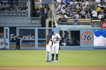 A special pre-game experience at Dodger Stadium where a child meets a baseball player on the field before a Los Angeles Dodgers game. 