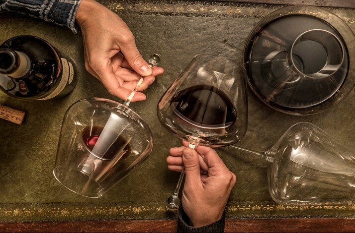 Close-up of wine glasses and a decanter on a leather mat at Little London