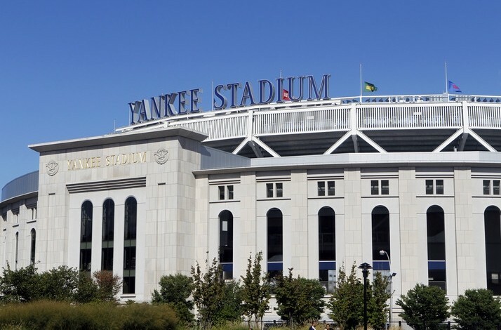  The image features Yankee Stadium, characterized by its distinctive white facade