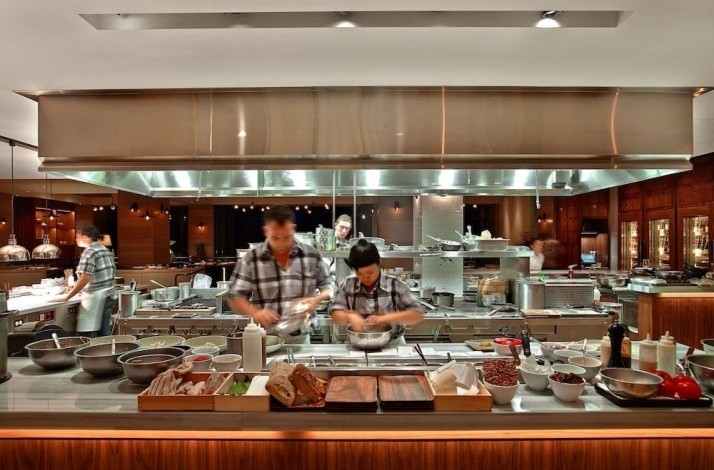 An open kitchen area with cooks at their work at the Andaz Maui at Wailea Resort.