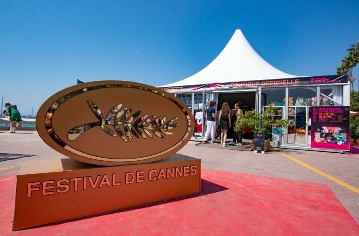 A golden Cannes Film Festival logo on the red carpet of the event