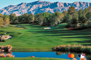 Lush fairways and sand bunkers of Shadow Creek golf course in Las Vegas, with mountain backdrop. Mastercard and MLB logos in lower-right corner.