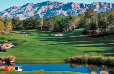 Lush fairways and sand bunkers of Shadow Creek golf course in Las Vegas, with mountain backdrop. Mastercard and MLB logos in lower-left corner.