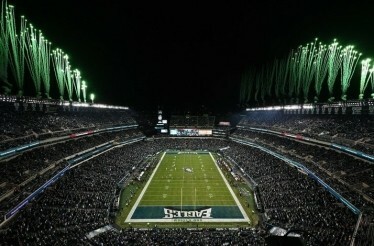 Fireworks show at a full Lincoln Financial Field at night.