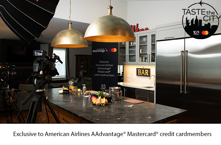 Cameras aimed at the kitchen with a Mastercard in Collaboration with American Airlines banner in the background.