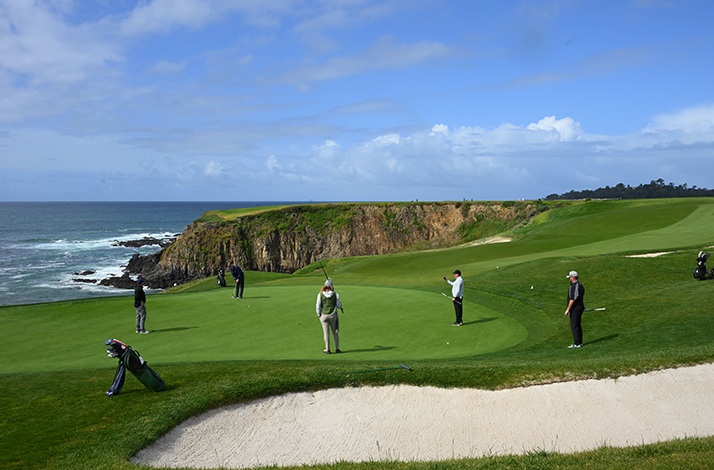A group of people playing golf at Pebble Beach Resort.
