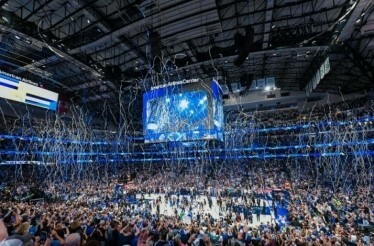 The crowds at the American Airlines Center cheering over a confetti release during a live NBA Dallas Mavs home game 