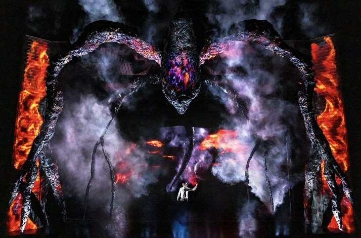 Scene from the Broadway's Stranger Things: The First Shadow performance: a giant birdlike creature hovering over person on the stage.