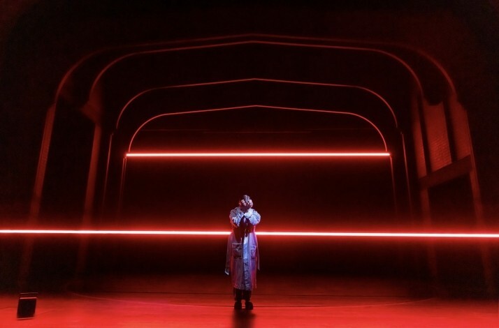 Scene from the Broadway's Stranger Things: The First Shadow performance: person standing in the middle of the stage and covering face with hands.