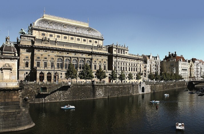 Exterior of Prague National Theatre by the river.