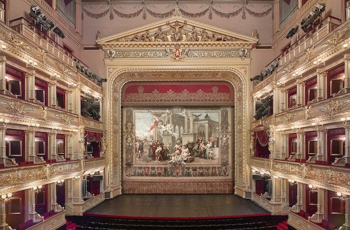 Ornate opera house interior with stage curtain
