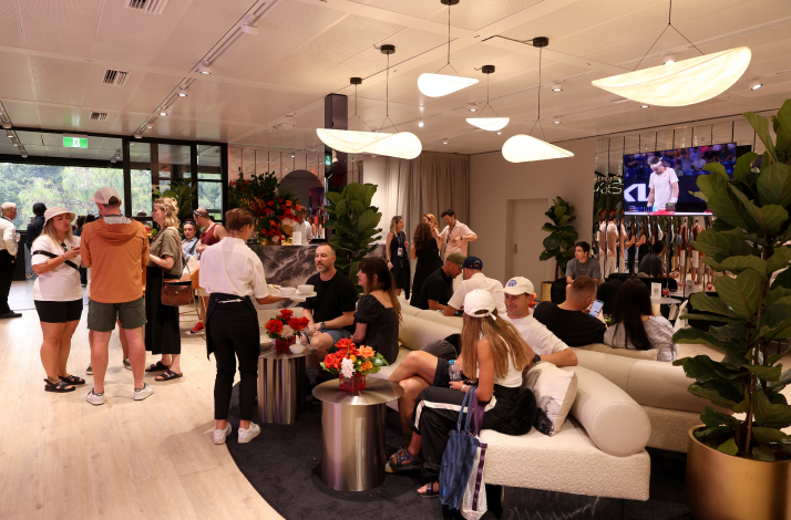 Guests relax and socialize in the Mastercard lounge, watching tennis on TV.