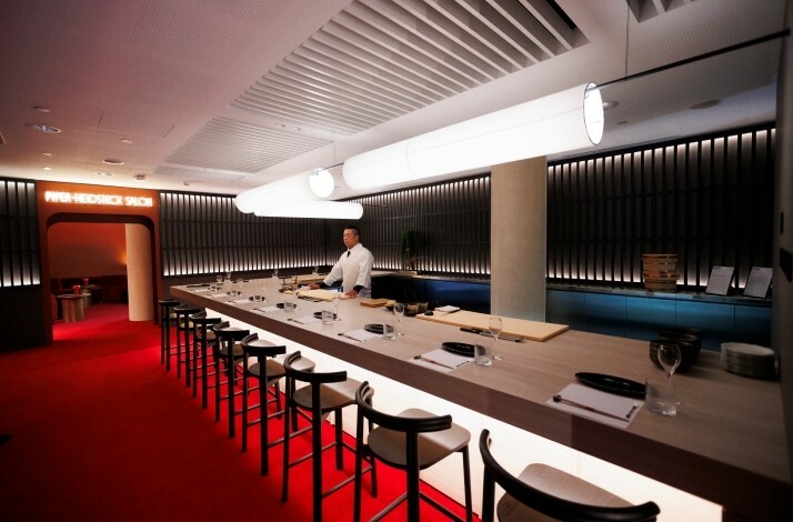 The chef is at the long table with an open kitchen in Rod Laver Arena in Melbourne.