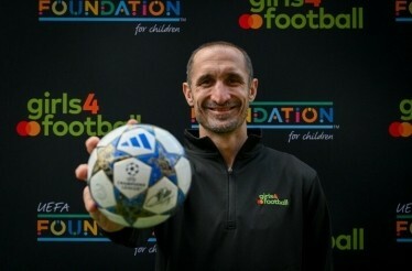 Giorgio Chiellini holding signed UEFA mini ball.