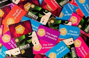 A bunch of colourful Theatre Tokens gift cards.
