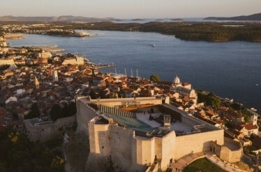Bird-eye view of St. Michael's Fortress and city of Šibenik at sunset.