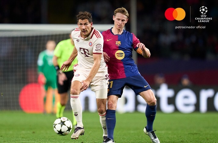 Footballers playing with the ball during UEFA champions league game.