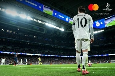 A footballer standing at the corner of the playground ready to kick the ball during UEFA Champions League game.