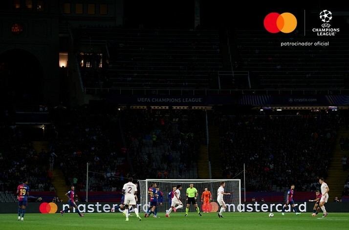 Footballers playing during UEFA champions league game.