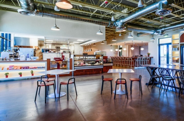 The spacious, modern rustic interior of the pizzeria and wine market Bar Bucce in Miami, Florida.