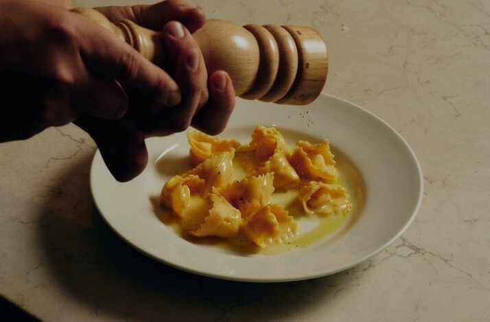 Homemade ravioli being seasoned with pepper at Antico Nuovo restaurant in Los Angeles.
