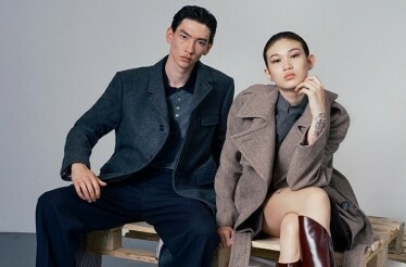 Male and female models posing sitting for the photo in YOOX fashion clothes