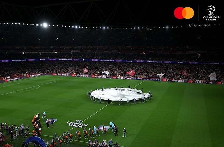 Large ball shaped flag on the middle of the football field before the UEFA match.