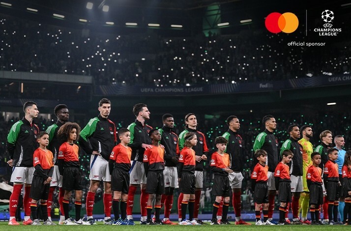 Players of Arsenal FC lining up on the field before an UEFA Champions League match