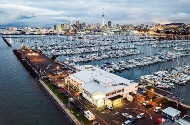 Birds eye-view at the Viaduct Marina Harbour with numerous yachts and cars driving by.