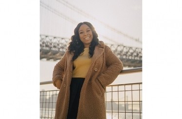 Roniesia Godfrey is standing beside bridge in New York.