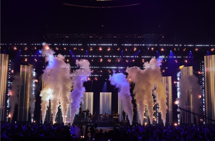 Latin GRAMMY Awards stage at MGM Grand Garden Arena filled with smoke effects, pyrotechnics, and dramatic lighting during a live performance.