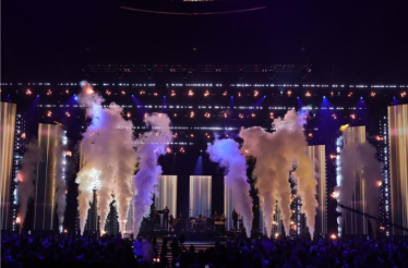 Latin GRAMMY Awards stage at MGM Grand Garden Arena filled with smoke effects, pyrotechnics, and dramatic lighting during a live performance.