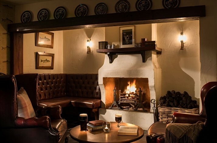 Interior of the Bushmills Inn with burning fireplace. 