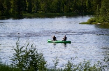 Two persons kayaking in a river