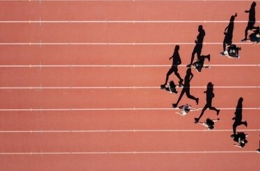 Runners on the running track of the Panathenaic Stadium in Athens, Greece.