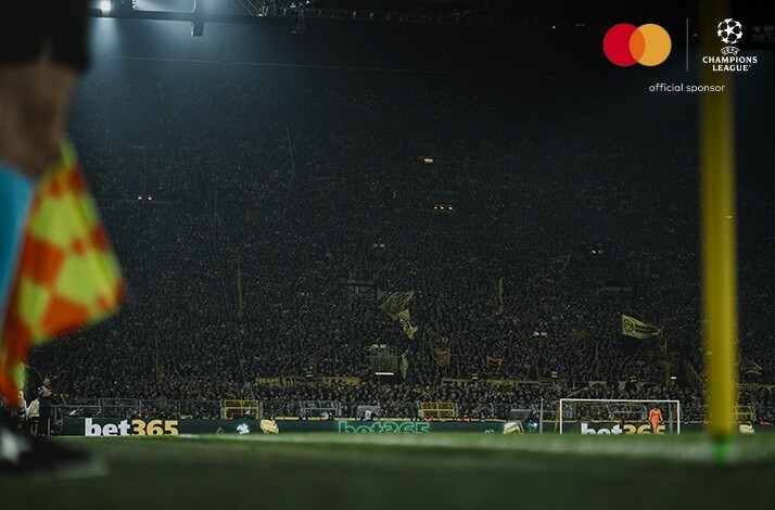 Football fans photographed at stadium stands during an UEFA Champions League match