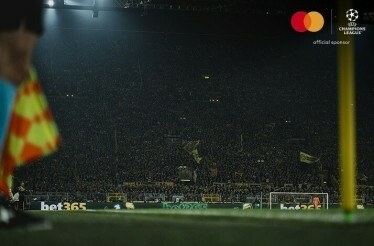 Football fans photographed at stadium stands during an UEFA Champions League match