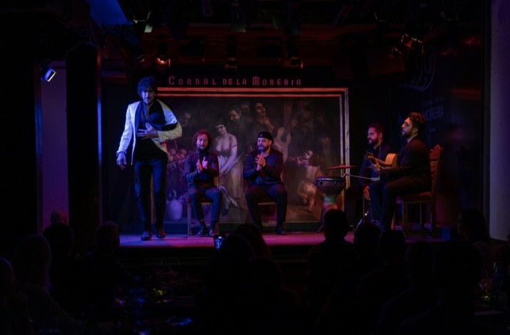 A flamenco performance on a dimly lit stage at Corral de la Morería.