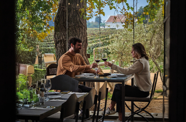 A couple enjoying wine glasses at Viu Manent Winery.