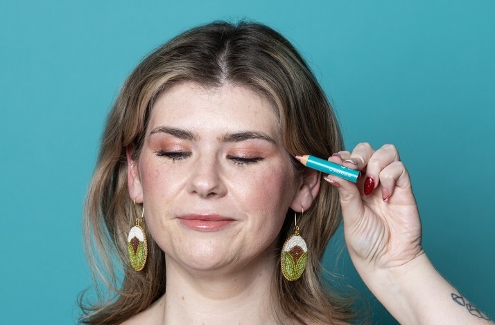 A model holding Rose Quartz eyeshadow up to her face.