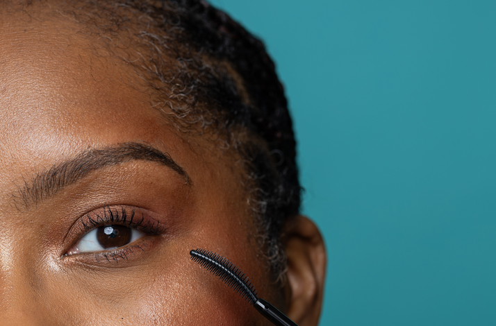 Close-up of a model applying Uprise mascara by Cheekbone Beauty.
