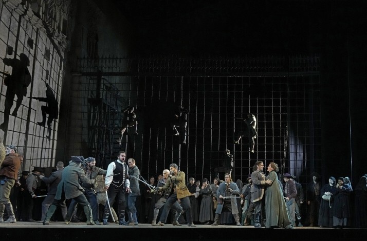 Actors interpreting a sword fight live on stage.