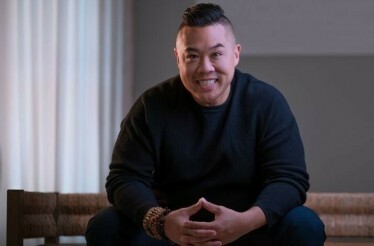 The portrait of the award-winning Chef Kelvin Cheung in black outfit smiling