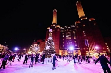 The luxurious building of Battersea Power Station, people ice skating