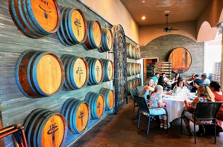 Dining area with wine caskets with Wilson Creek Winery logo along the wall.