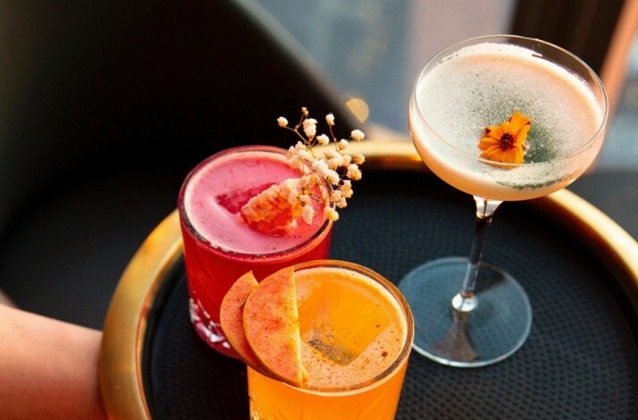 Tray with three colorful cocktails served at Peak restaurant.