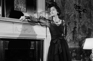 Black and white photo of Coco Chanel in a luxurious interior