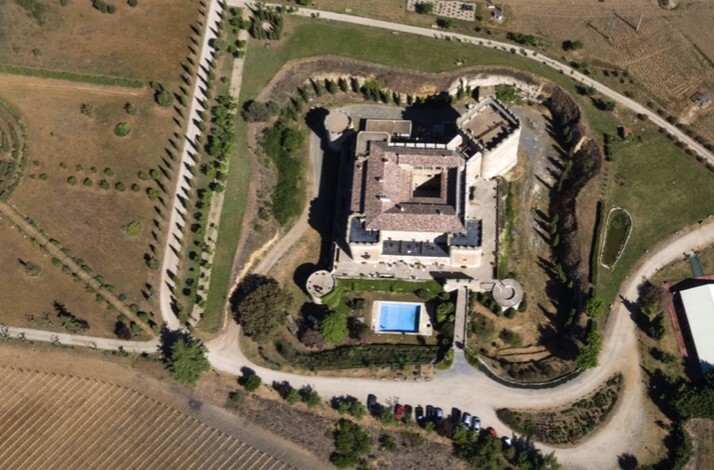 Aerial view of Castillo del Buen Amor fortress and grounds, surrounded by countryside in Salamanca.