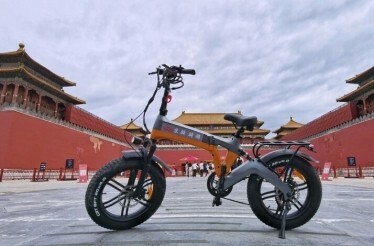 Power assisted cycle parked in front of the Forbidden City in Beijing.