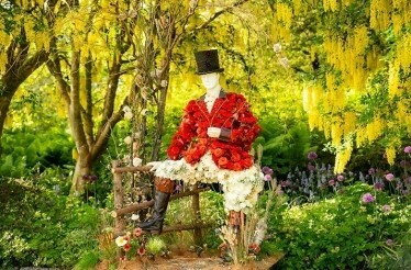 A figure in a costume made out of flowers at the Fleurs de Villes Downton Abbey exhibition